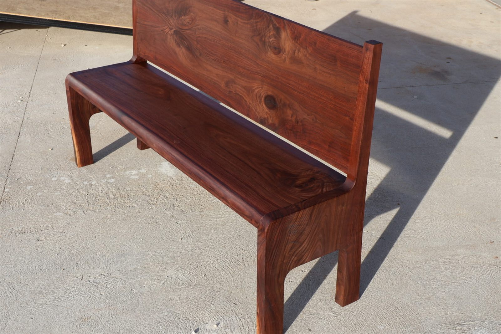 Black walnut bench with a back, built from milled walnut