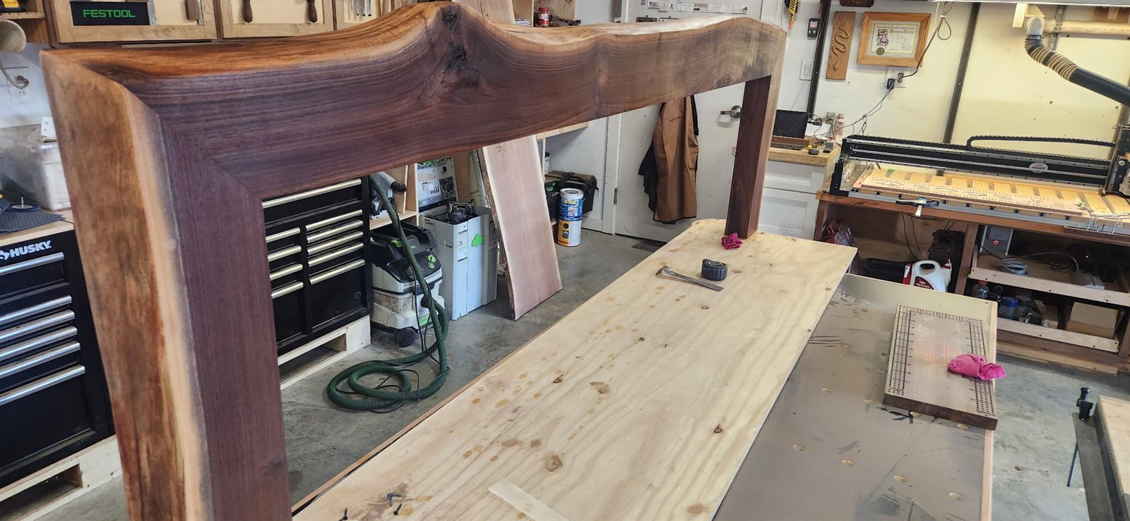 Live edge black walnut fireplace mantel in the woodshop