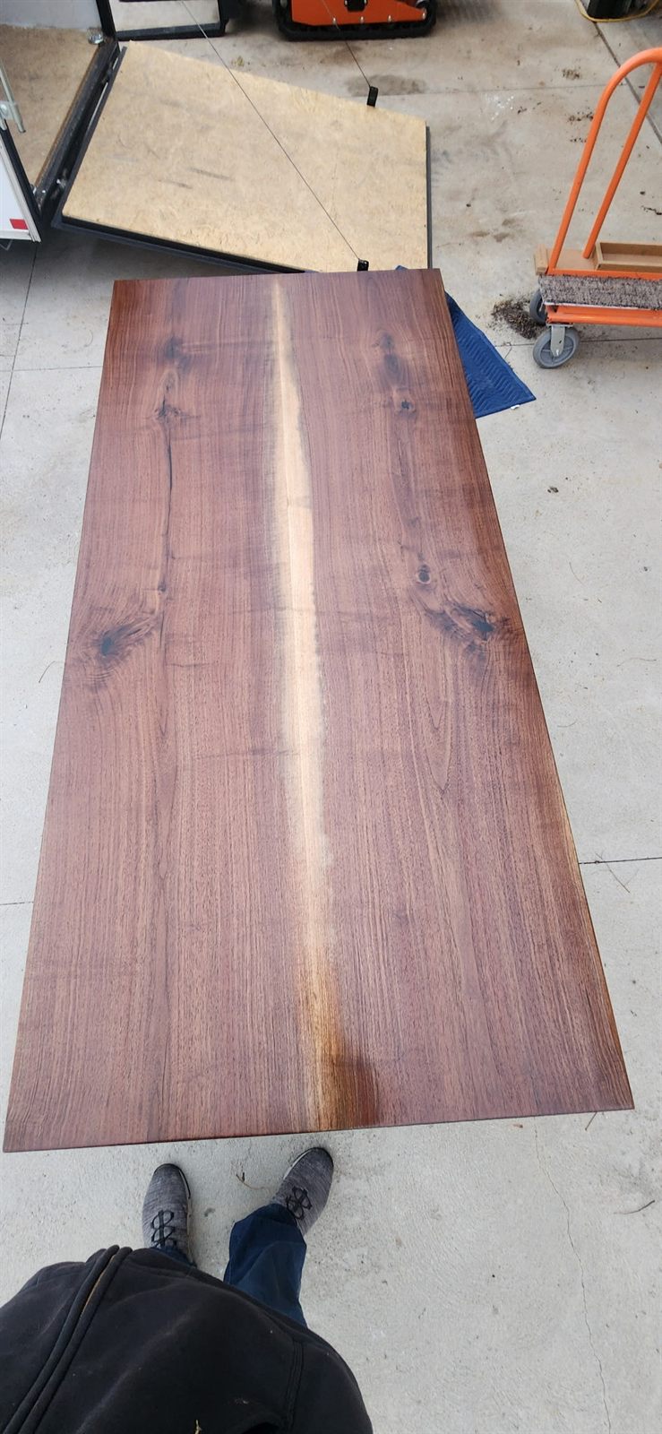 Finished black walnut table top showing the grain and figure